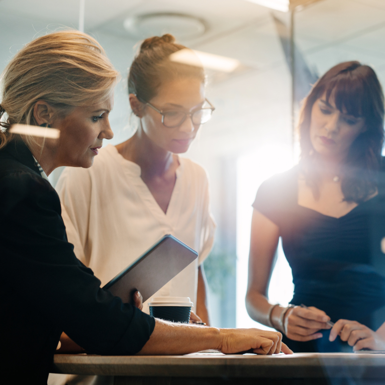 Three women discussing a business plan.