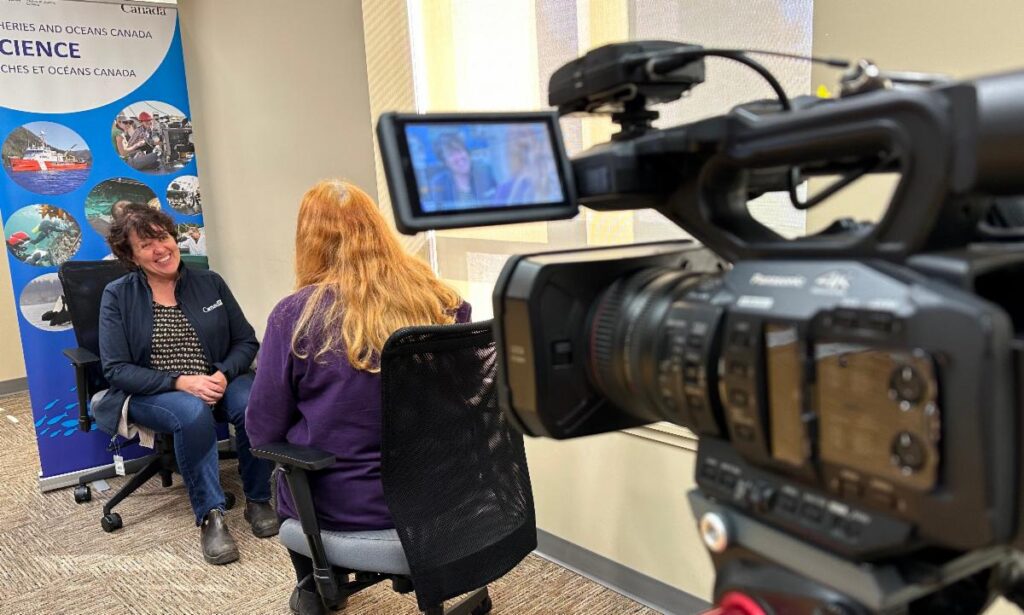 A video camera records an interview with Robyn Quinn, teaching how to give news interviews at workshops in Victoria